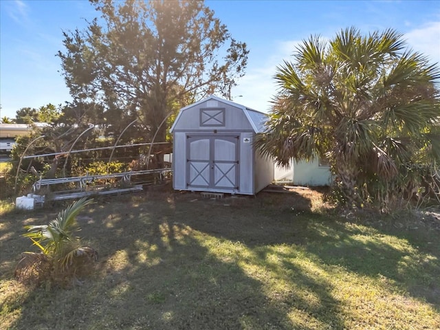 view of outdoor structure featuring a lawn