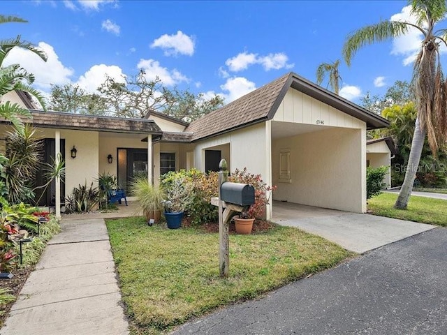 ranch-style house with a carport and a front yard