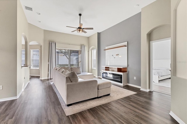 living room featuring ceiling fan and dark hardwood / wood-style flooring