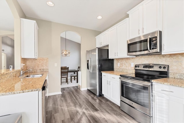 kitchen featuring pendant lighting, white cabinetry, sink, and appliances with stainless steel finishes