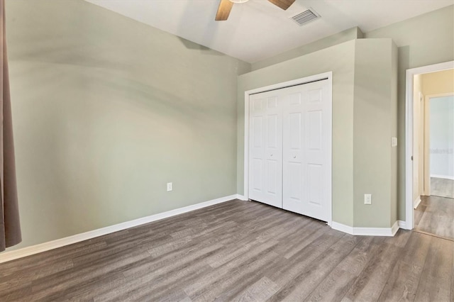 unfurnished bedroom with a closet, ceiling fan, and hardwood / wood-style flooring