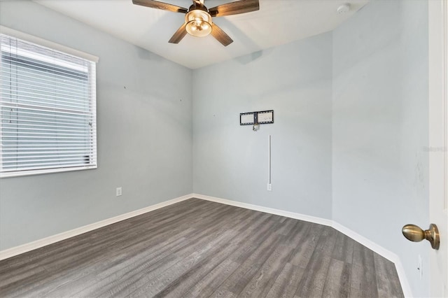 spare room with dark hardwood / wood-style flooring and ceiling fan