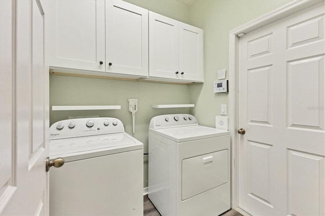 washroom featuring cabinets and independent washer and dryer