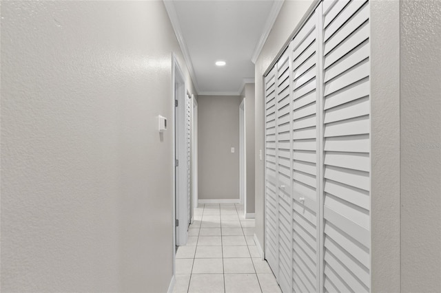 hall with light tile patterned flooring and ornamental molding