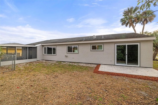 back of house with a patio area and a sunroom