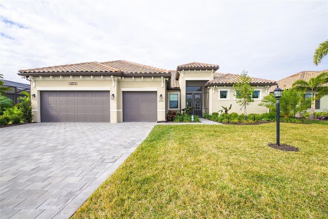 mediterranean / spanish house with a front yard and a garage