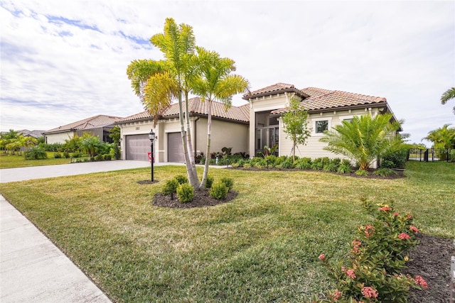 mediterranean / spanish-style house with a garage and a front lawn