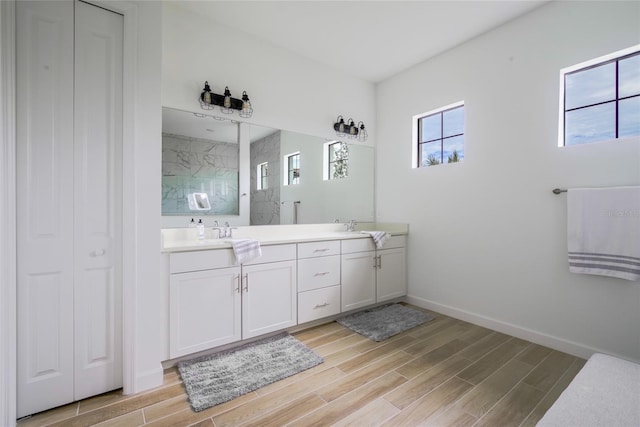 bathroom featuring a shower and vanity