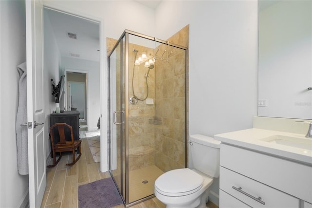 bathroom with vanity, toilet, and walk in shower