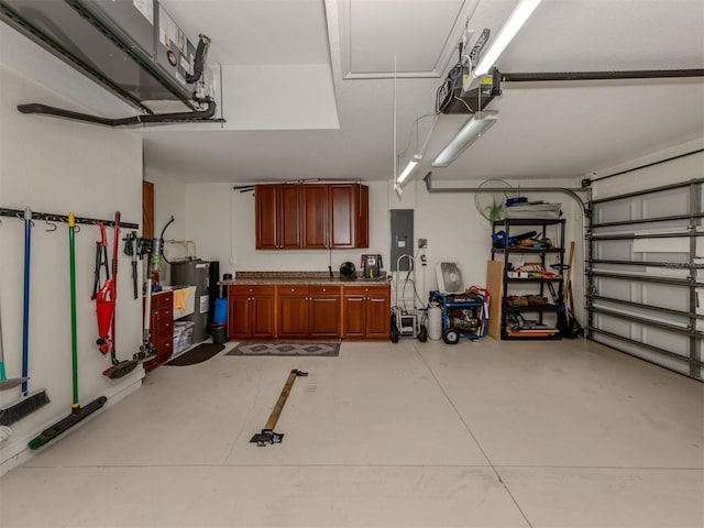 garage with electric panel, water heater, and a garage door opener