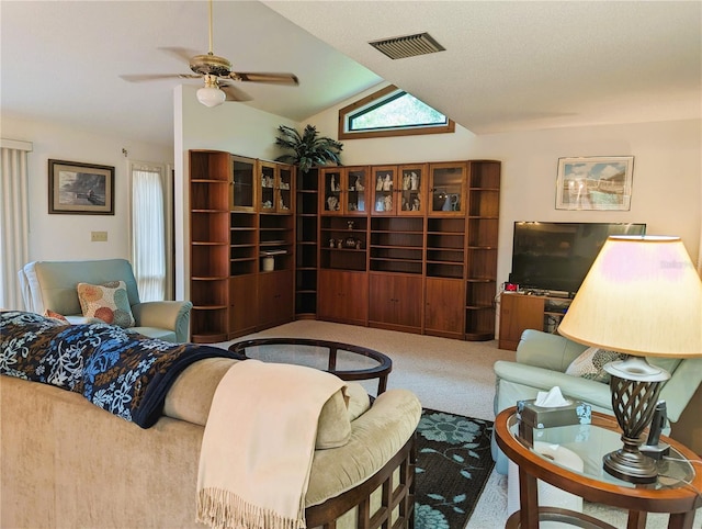 living room featuring ceiling fan, light colored carpet, and vaulted ceiling