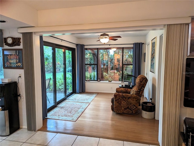 interior space featuring ceiling fan, plenty of natural light, and light tile patterned flooring