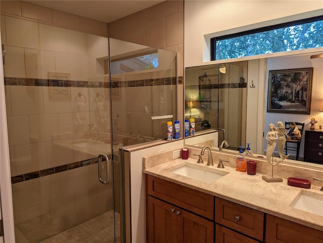 bathroom featuring vanity and a shower with shower door