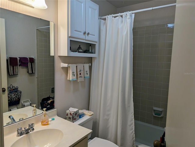 full bathroom featuring vanity, toilet, and shower / tub combo