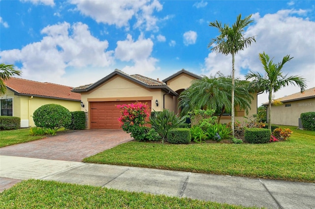 view of front of home featuring a garage and a front lawn