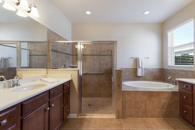 full bathroom with tile patterned floors, vanity, a shower stall, a bath, and recessed lighting