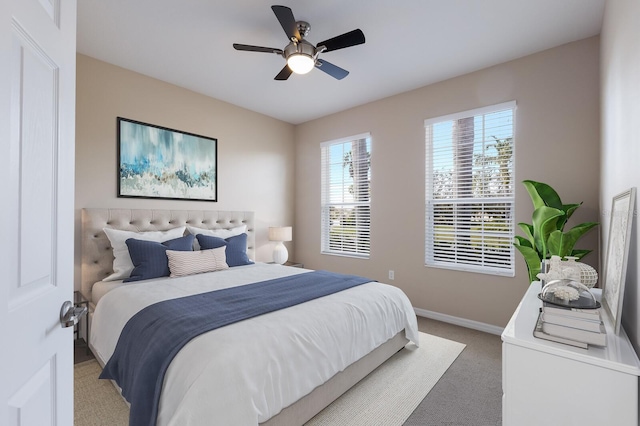 bedroom with light carpet, ceiling fan, and baseboards