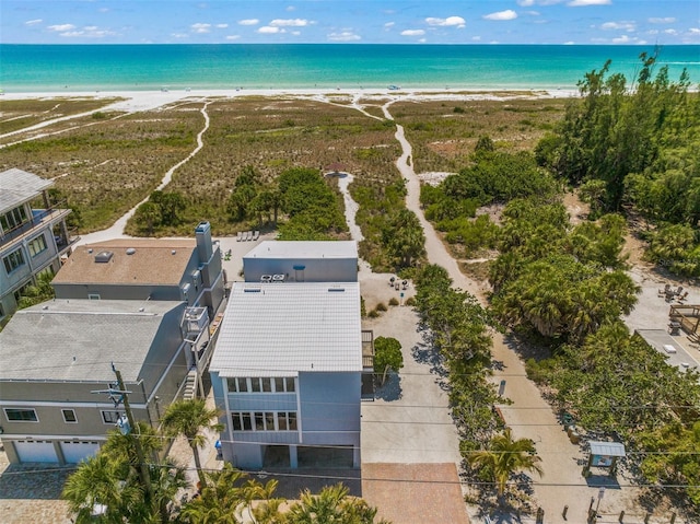 bird's eye view featuring a water view and a beach view