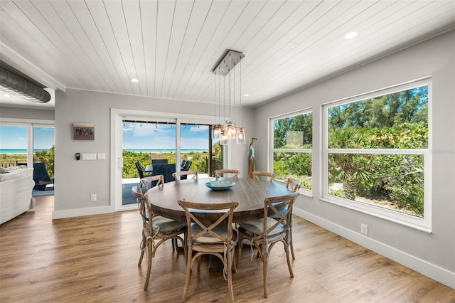 dining room with hardwood / wood-style flooring and wood ceiling