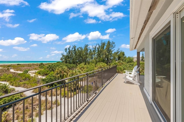 balcony featuring a water view and a view of the beach