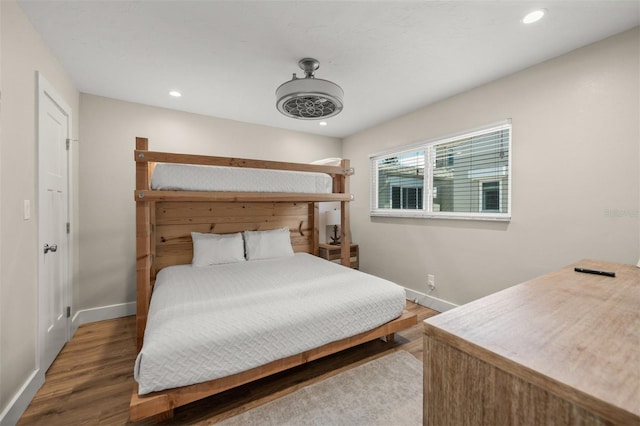 bedroom with dark hardwood / wood-style floors