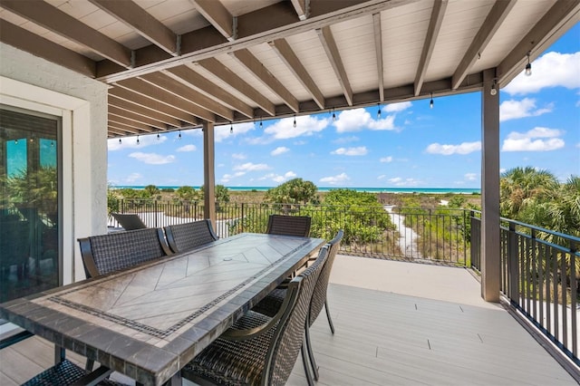 wooden terrace featuring a water view