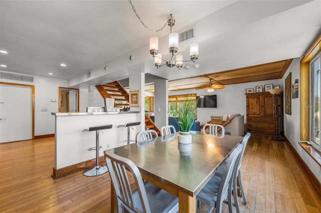 dining area featuring light hardwood / wood-style floors and a notable chandelier