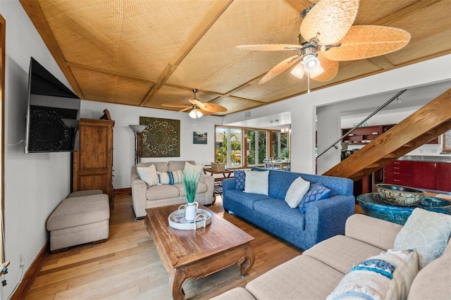 living room featuring ceiling fan and light hardwood / wood-style flooring