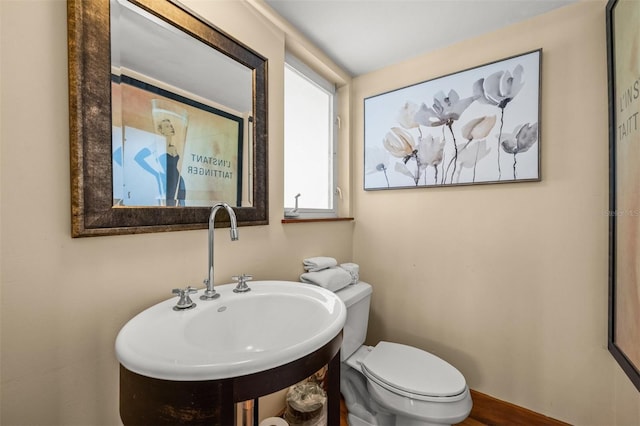 bathroom featuring sink and toilet