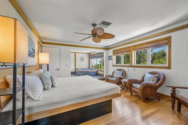 bedroom featuring ceiling fan, ornamental molding, and hardwood / wood-style floors