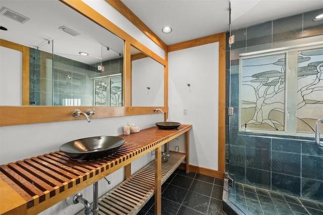 bathroom with a shower with door and vanity