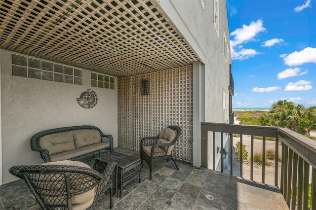 balcony with a water view and an outdoor living space