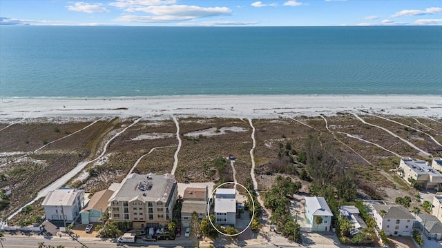 birds eye view of property with a water view and a view of the beach