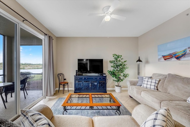 living room with ceiling fan and light tile patterned floors