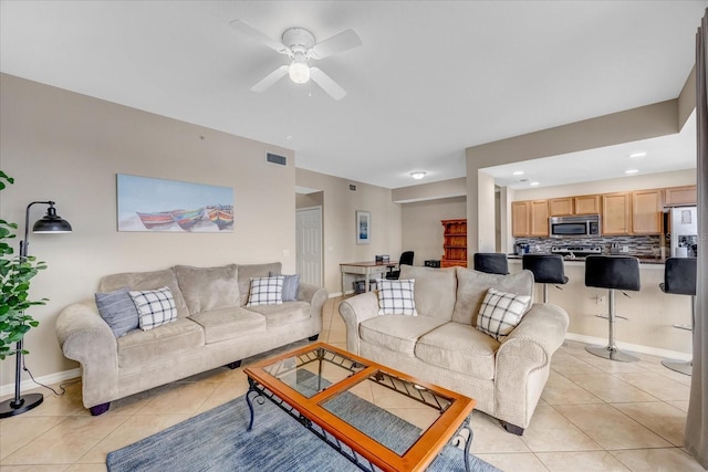 tiled living room featuring ceiling fan