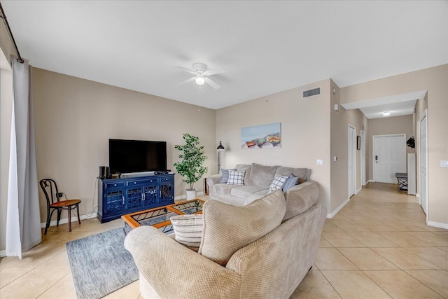 tiled living room with ceiling fan