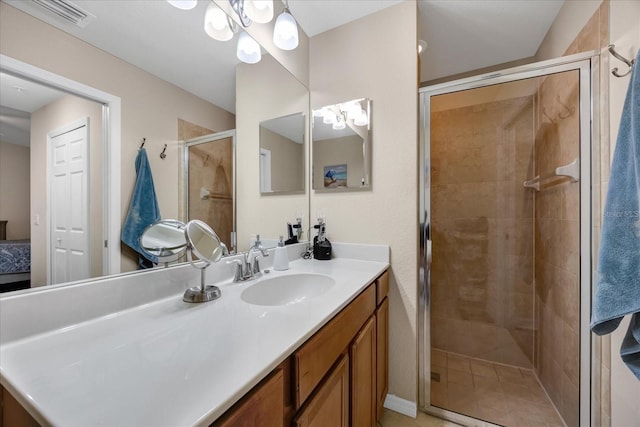 bathroom with vanity, a notable chandelier, and a shower with door