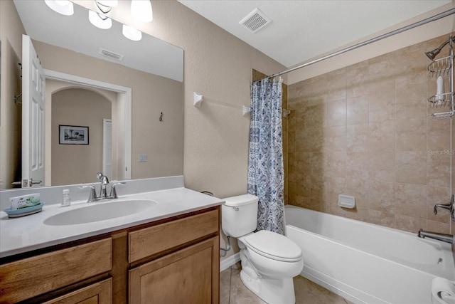 full bathroom featuring toilet, vanity, tile patterned flooring, and shower / bathtub combination with curtain