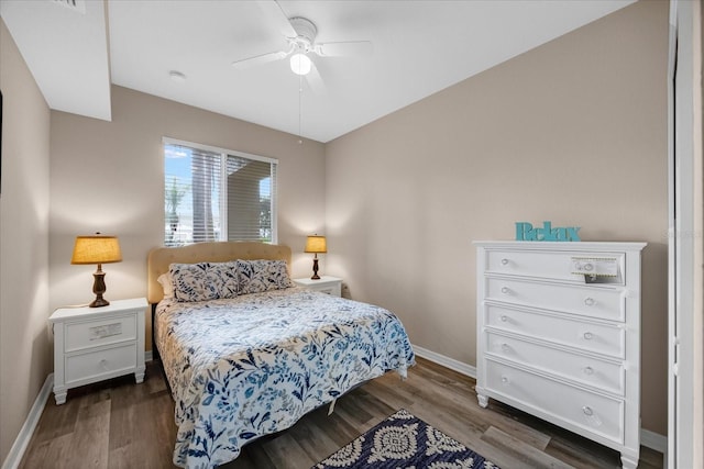 bedroom with ceiling fan and dark hardwood / wood-style floors