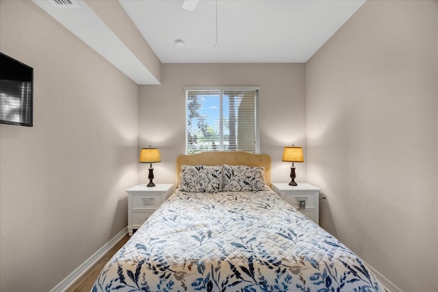 bedroom with ceiling fan and wood-type flooring