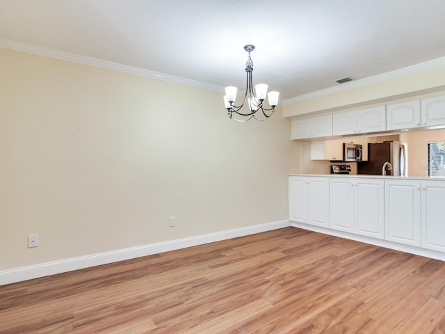 unfurnished dining area featuring a notable chandelier, crown molding, and light hardwood / wood-style flooring