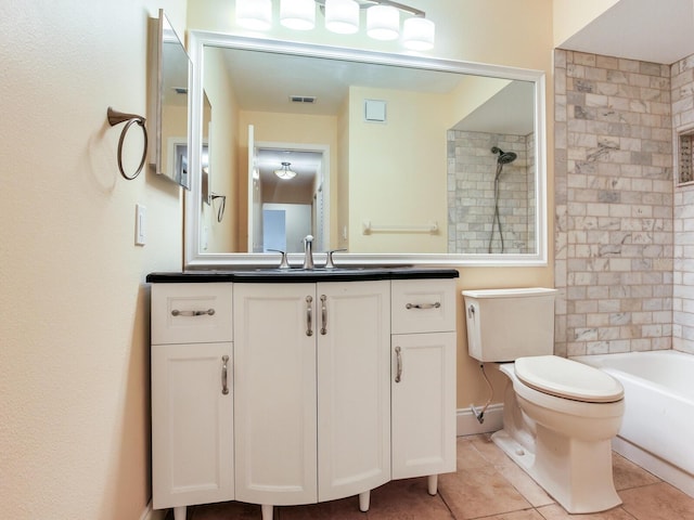 full bathroom with tile patterned flooring, vanity, toilet, and tiled shower / bath