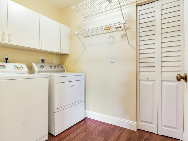 clothes washing area with cabinets, separate washer and dryer, and dark hardwood / wood-style floors