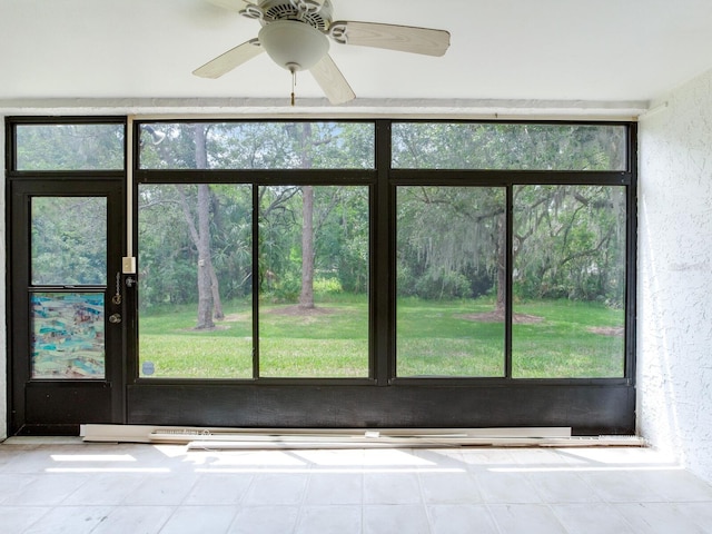 interior space featuring ceiling fan and a healthy amount of sunlight