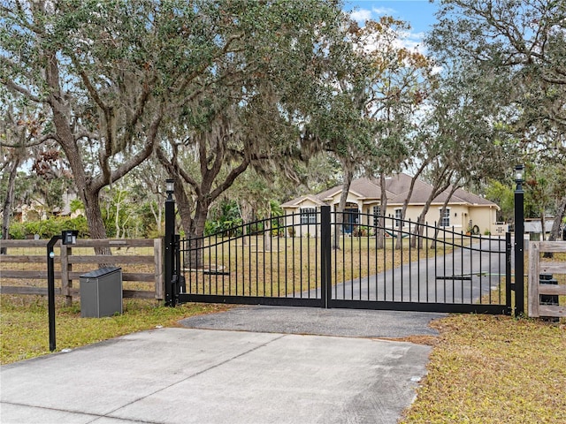 view of gate featuring a lawn