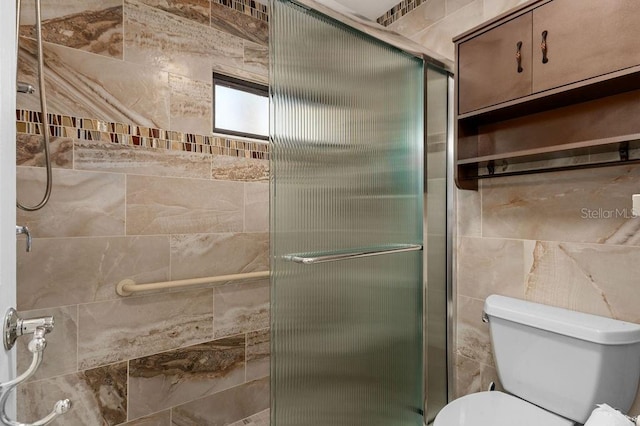 bathroom featuring a shower stall and toilet