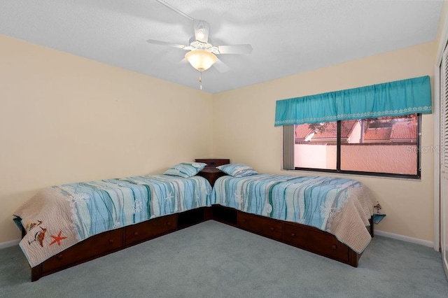 carpeted bedroom featuring a ceiling fan and baseboards