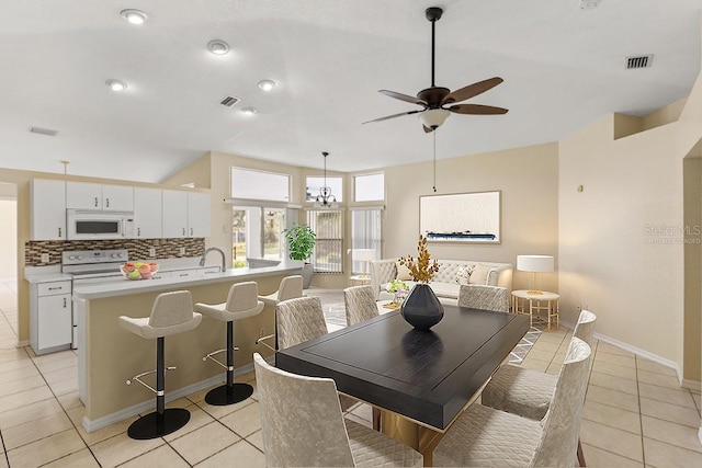 dining space with ceiling fan and light tile patterned floors