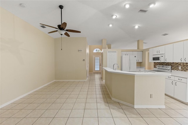 kitchen with white appliances, ceiling fan, a center island with sink, white cabinetry, and lofted ceiling