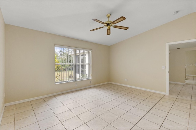 tiled spare room with ceiling fan